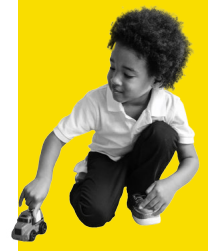 Photo of a litle boy playing with a toy car